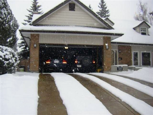 A radiant heated driveway with heated tire tracks